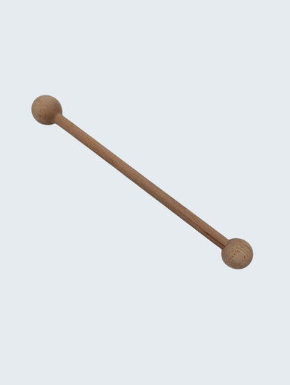 wooden double ended ball stylus on an off white background