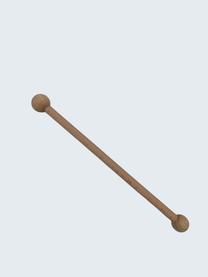 wooden double ended ball stylus on an off white background