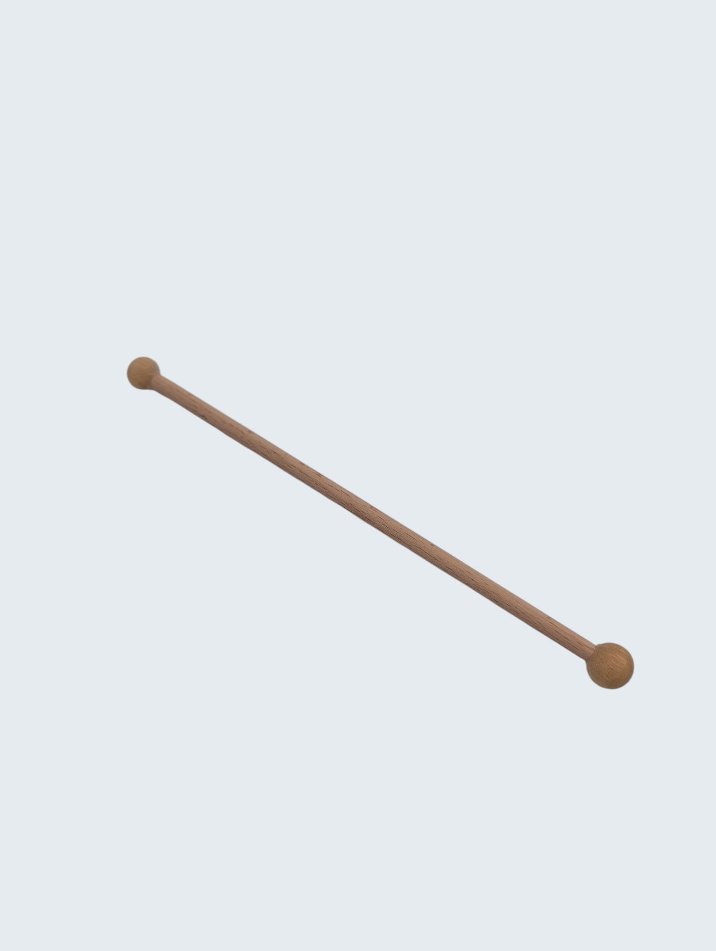 wooden double ended ball stylus on an off white background