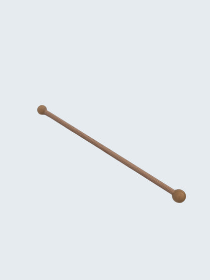 wooden double ended ball stylus on an off white background